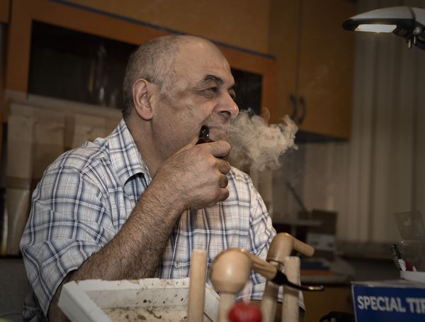 Levon Asikyan at the bench, smoking among unfinished pipes