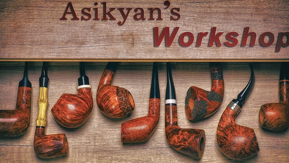 A row of Asikyan pipes under a wooden sign reading Asikyan’s Workshop